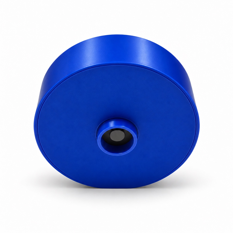 Underside of the compact cobalt-blue Salt Puck showing the recessed salt-level sensor